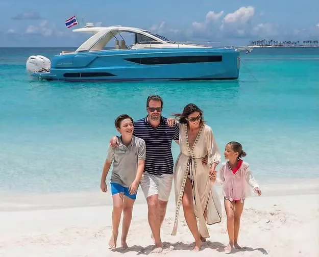 Family on beach with yacht in Phuket
